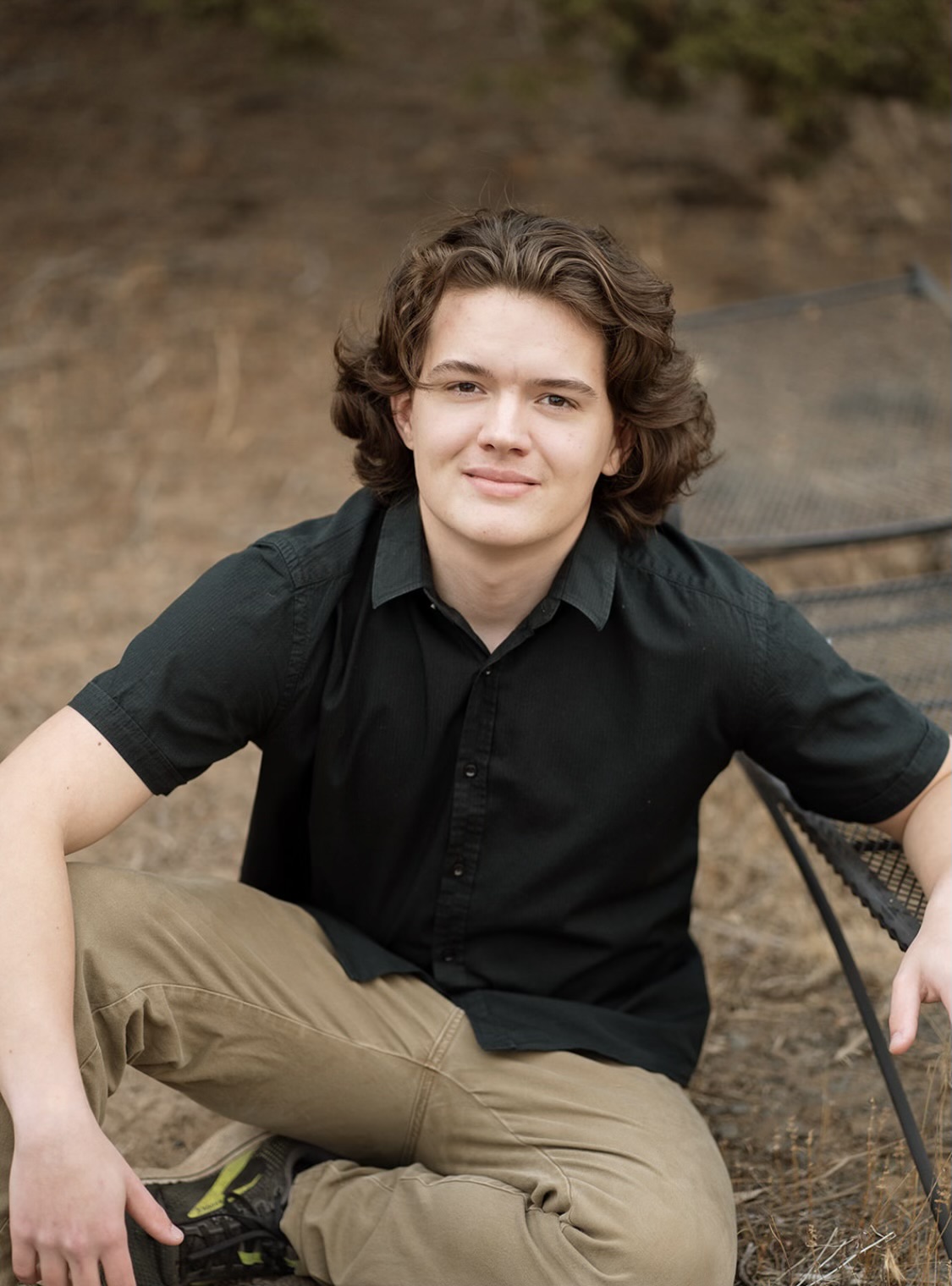 Kaden Buch seated outdoors near a mountain view