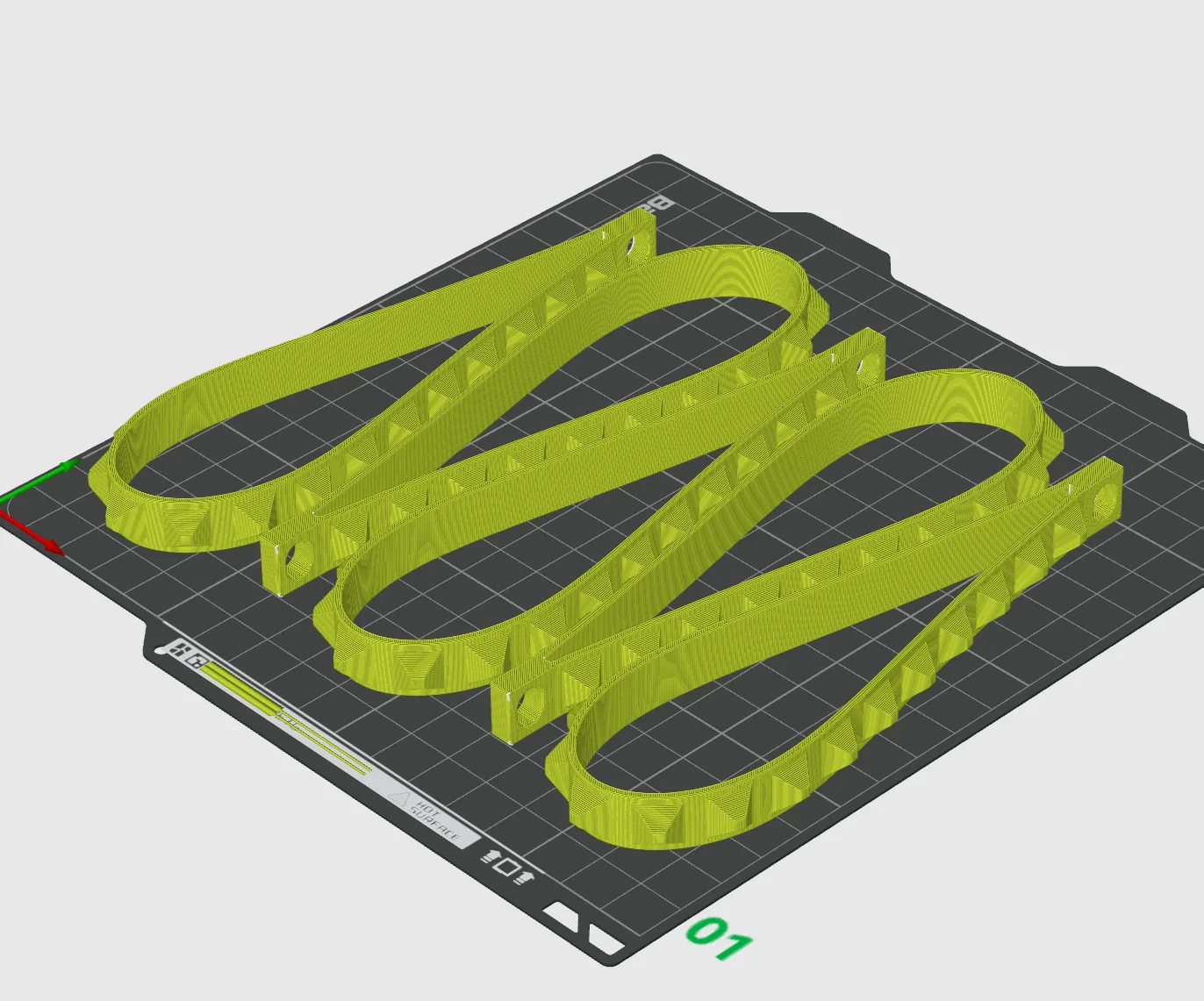 Several wrist strap models arranged together on a 3D printer build plate