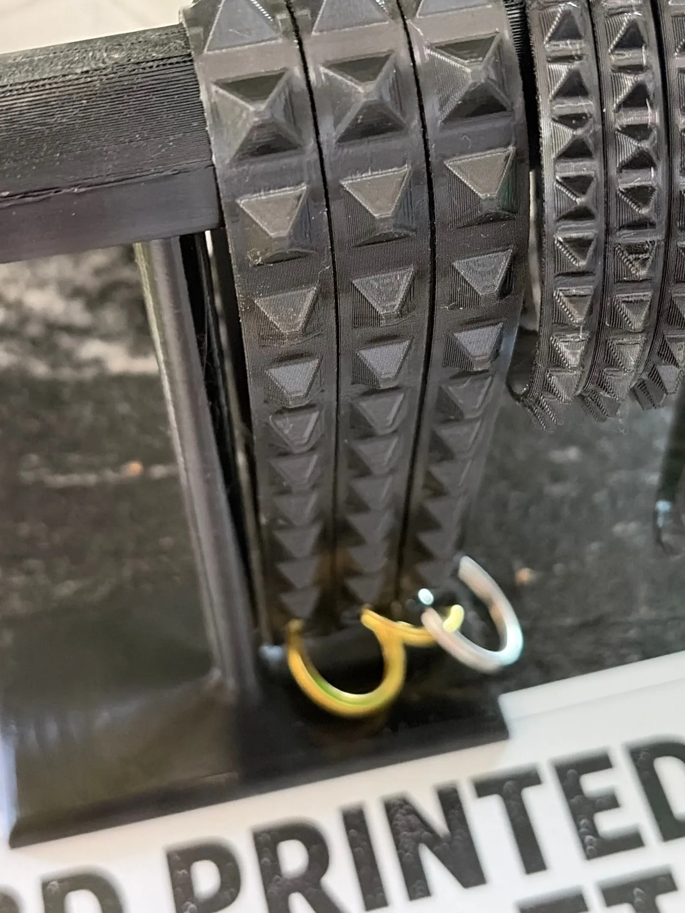 Close-up of black TPU bracelets showing small repeated surface details