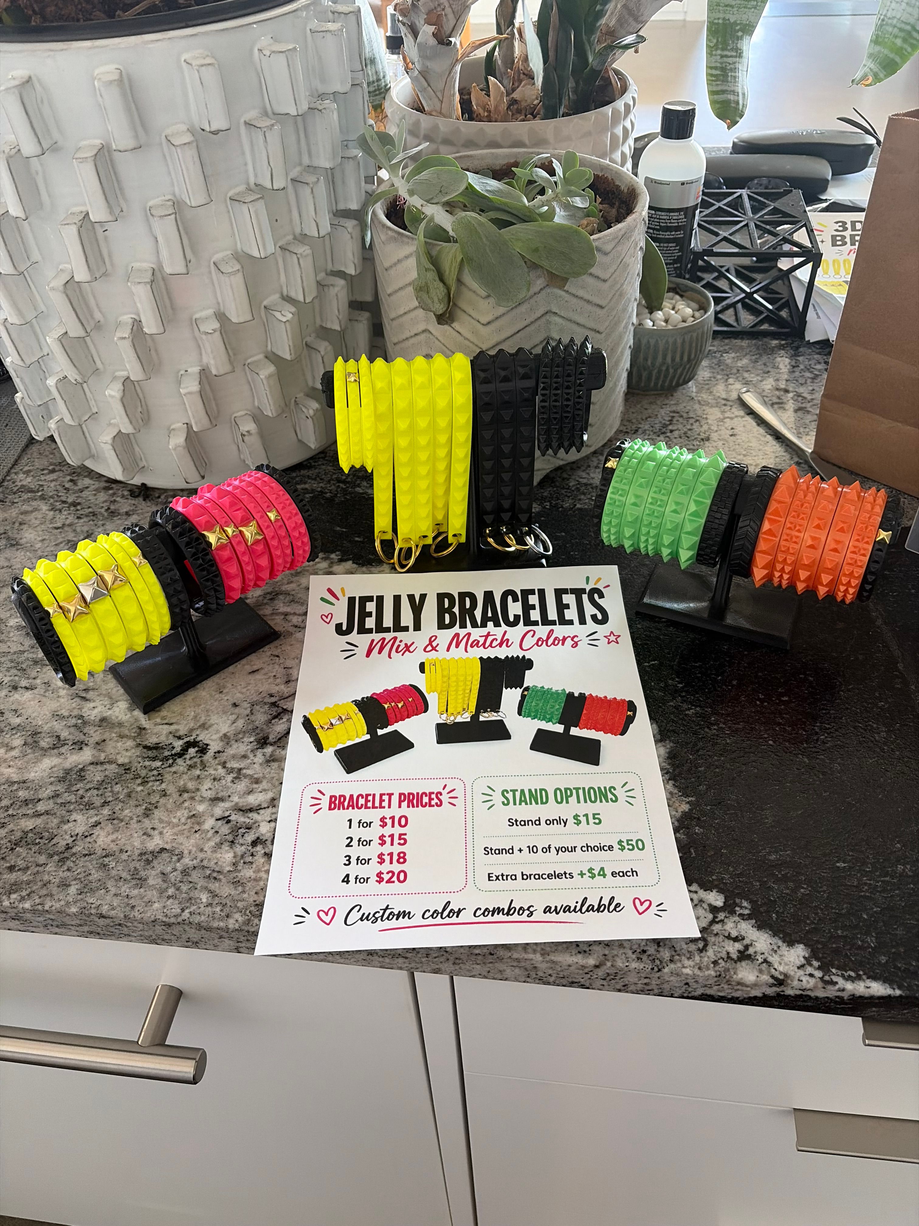 Colorful 3D printed bracelets and wrist straps arranged with printed display pieces