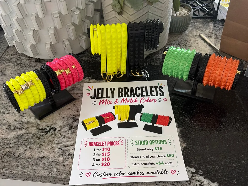 Colorful 3D printed bracelets and wrist straps arranged with printed display pieces